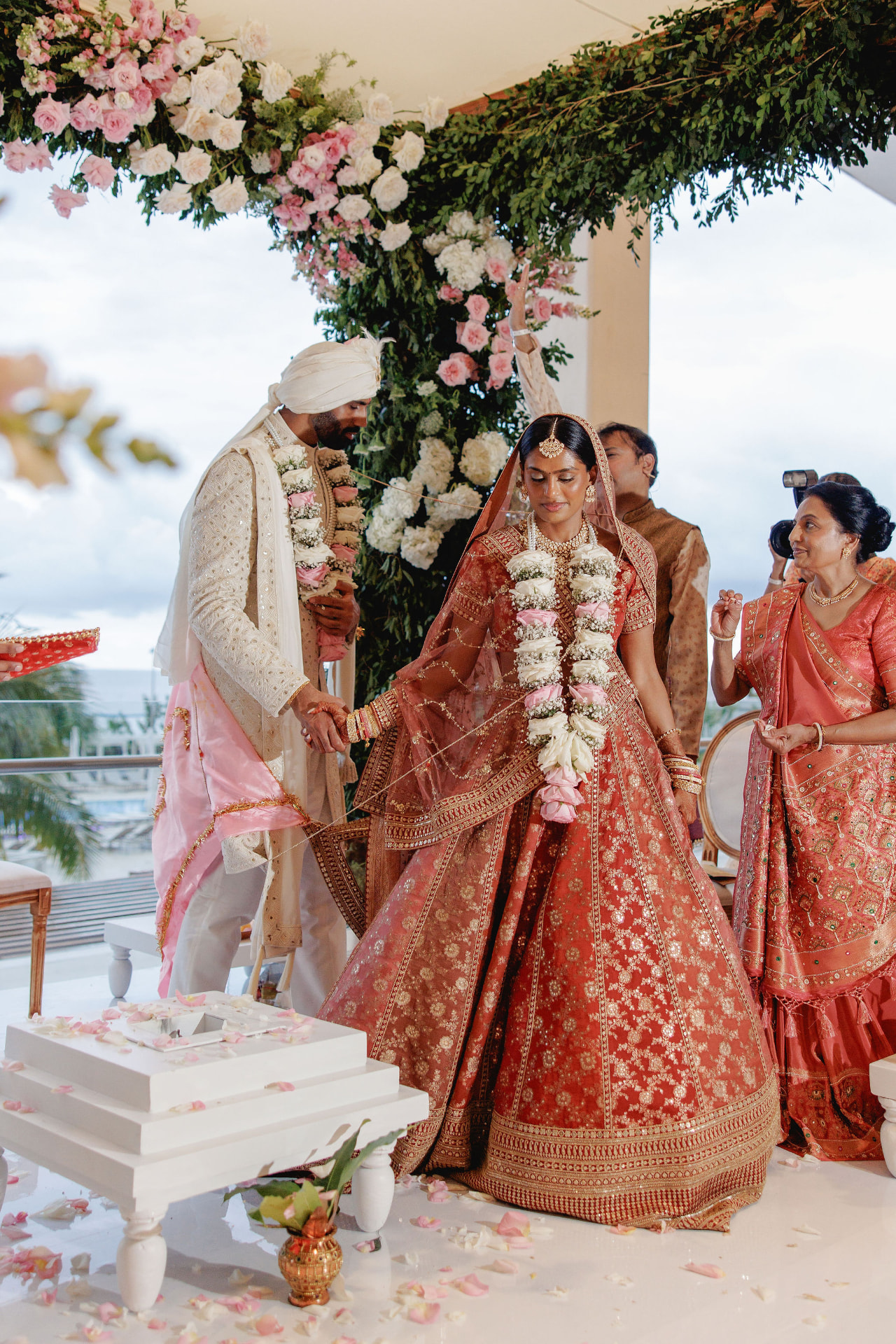 Shivam and Prarthi during their ceremony beneath a floral canopy