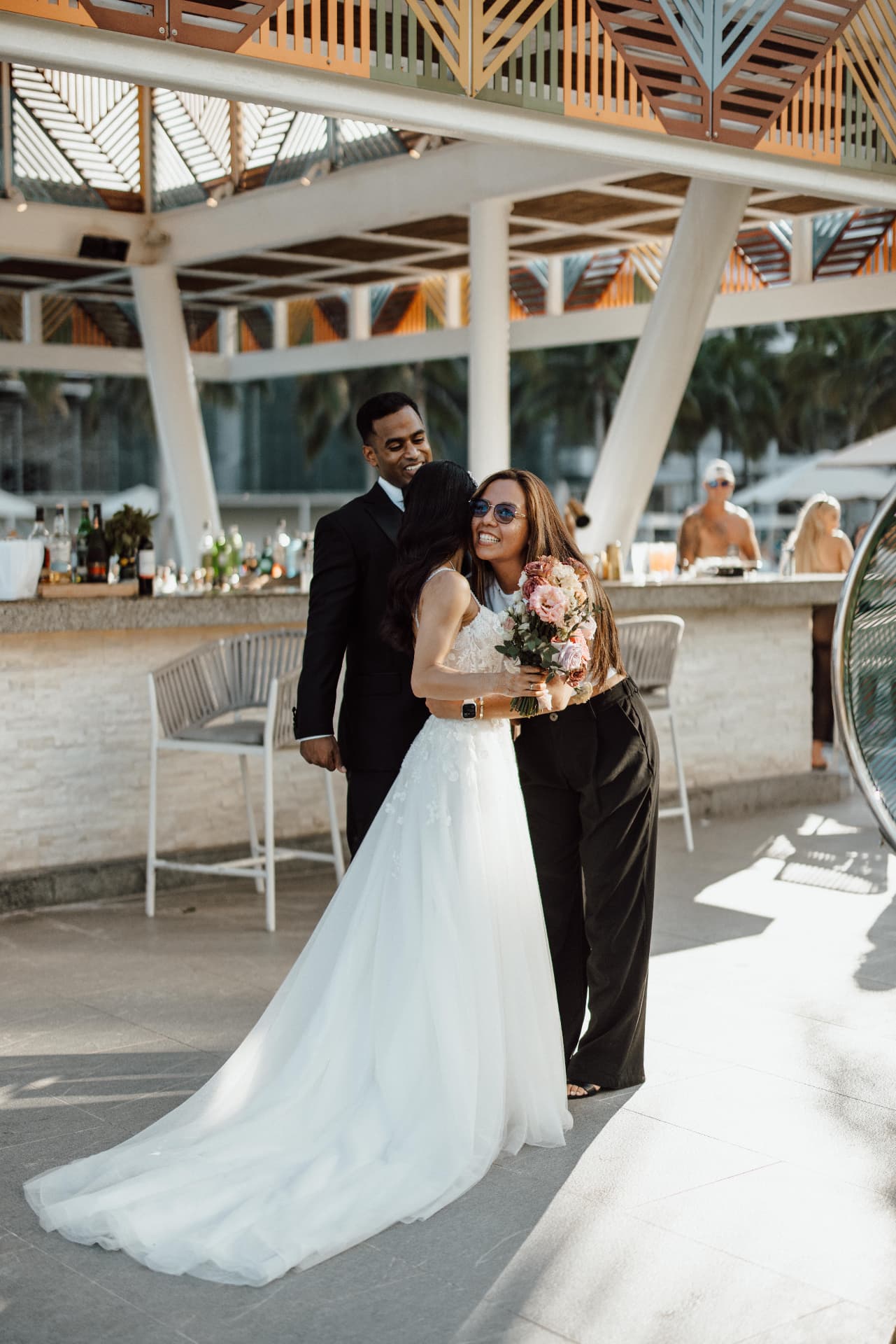 The bride with two companions in a bright resort setting