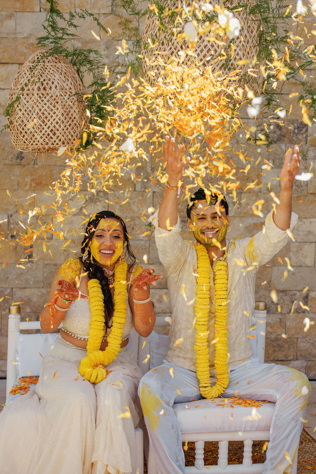 The couple throwing petals during the Pithi