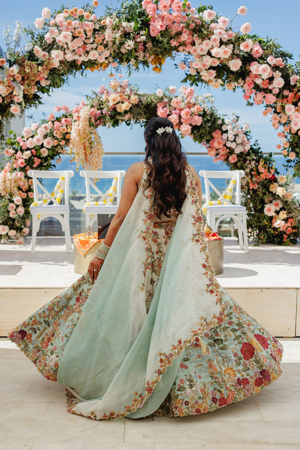 The bride beneath floral arches