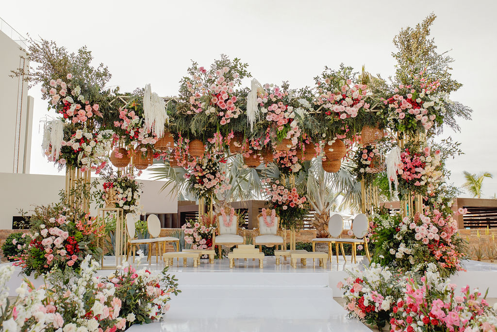 Floral ceremony stage with white seating