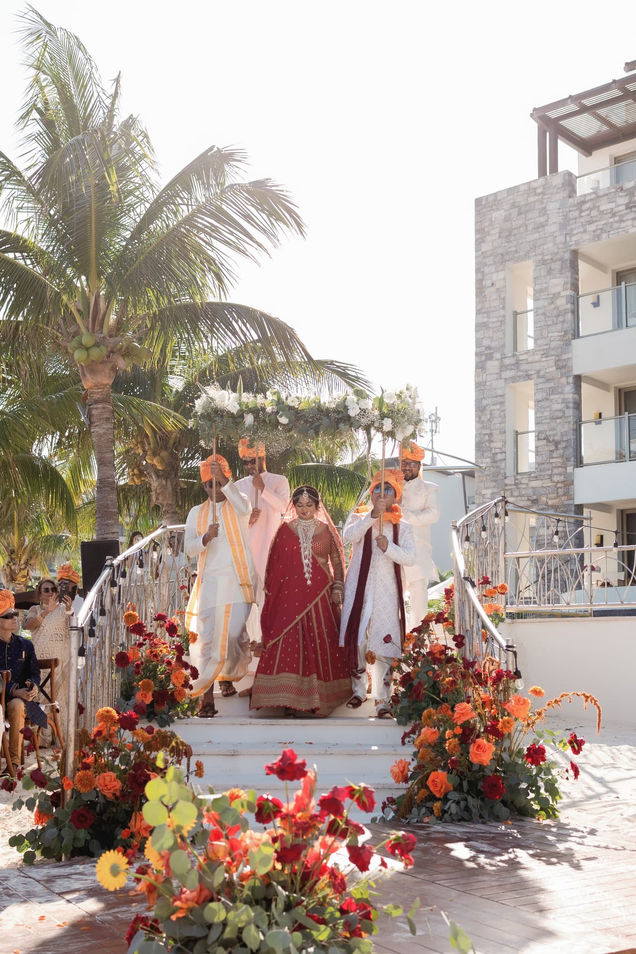 Wedding procession on flower-lined stairs