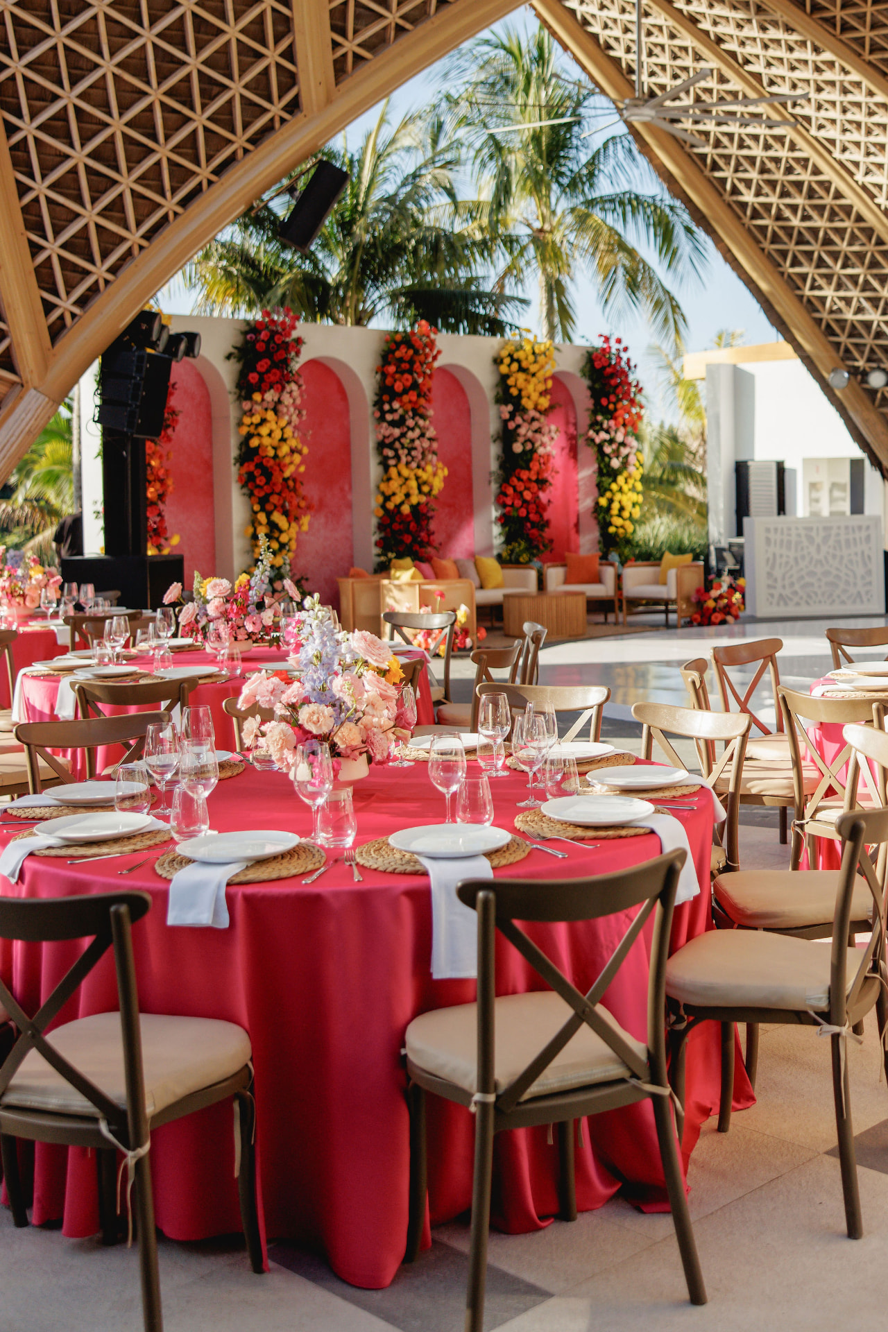 Colourful reception tablescape beneath a geometric canopy