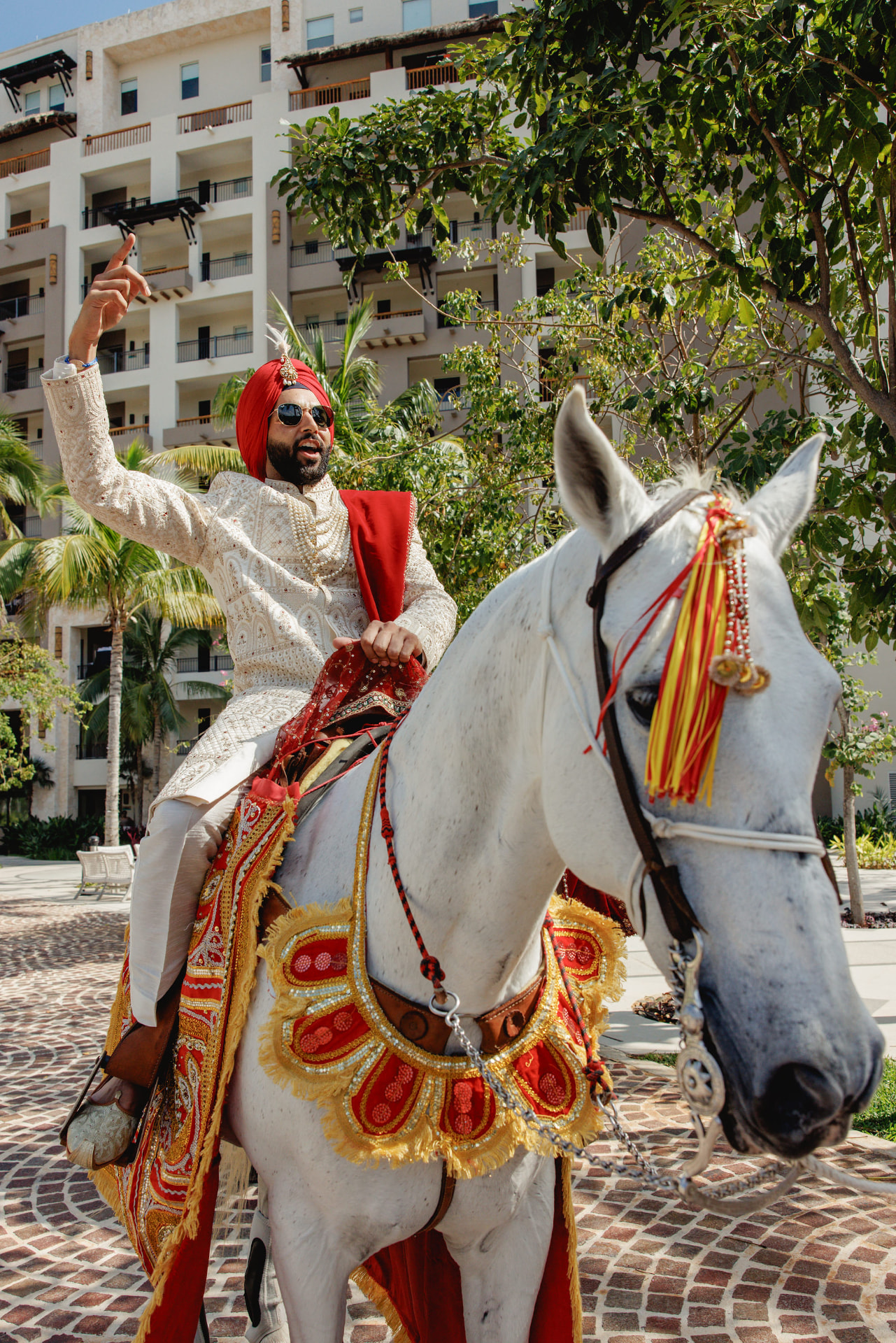 The groom arriving for the Baraat on a decorated white horse