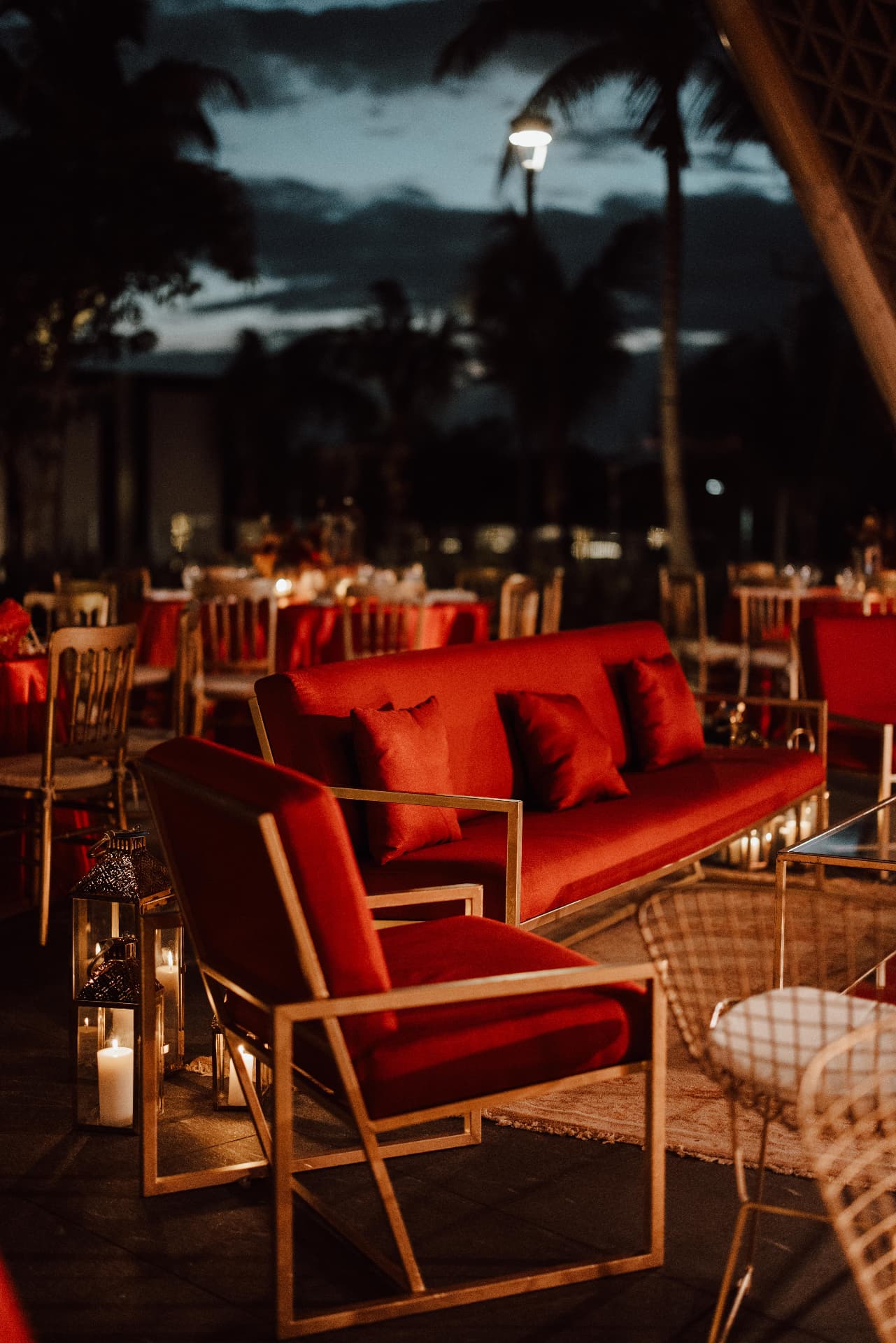 Red lounge and candlelit reception setting at night