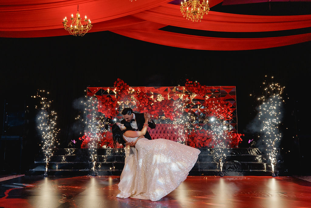 First dance with sparks in front of the red floral stage